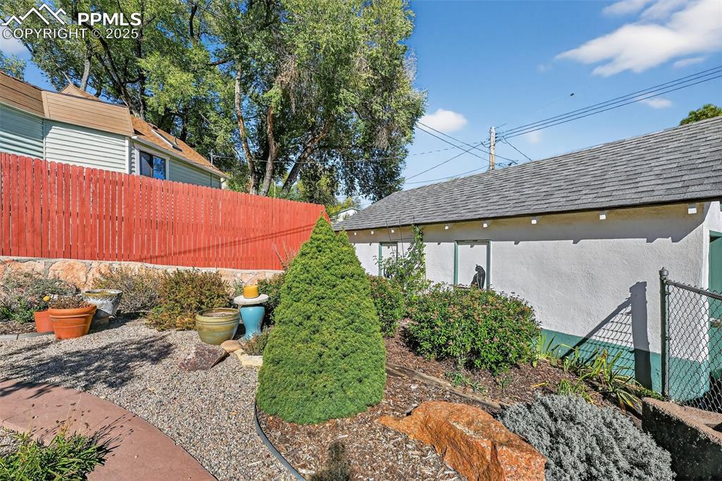 Image 36 of 46: Garden and Side of One Detached Garage