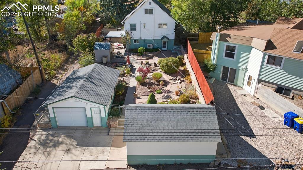 Image 41 of 46: Back aerial view of home, garden and garages
