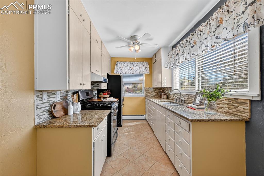 Image 9 of 46: Original cabinets and granite countertops Main level