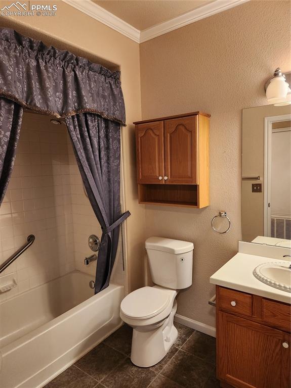 Image 15 of 19: Full bathroom featuring crown molding, a textured wall, shower / bath combo