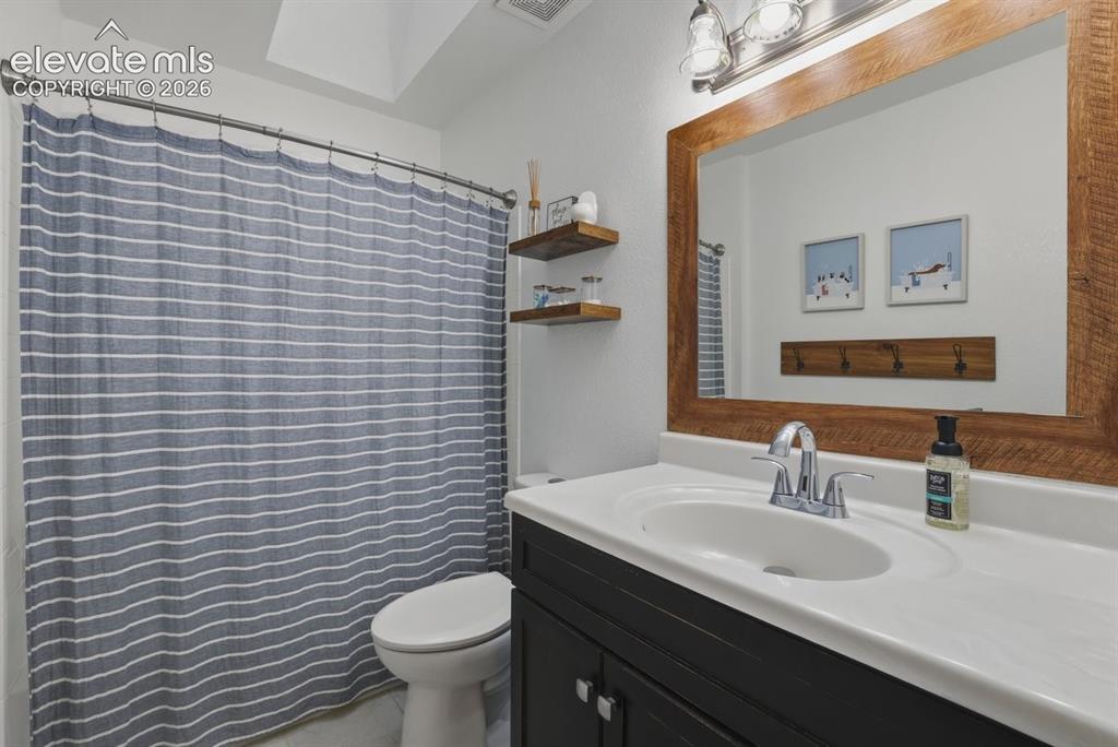 Image 29 of 45: beautifully updated main level guest bathroom with a skylight for added nat