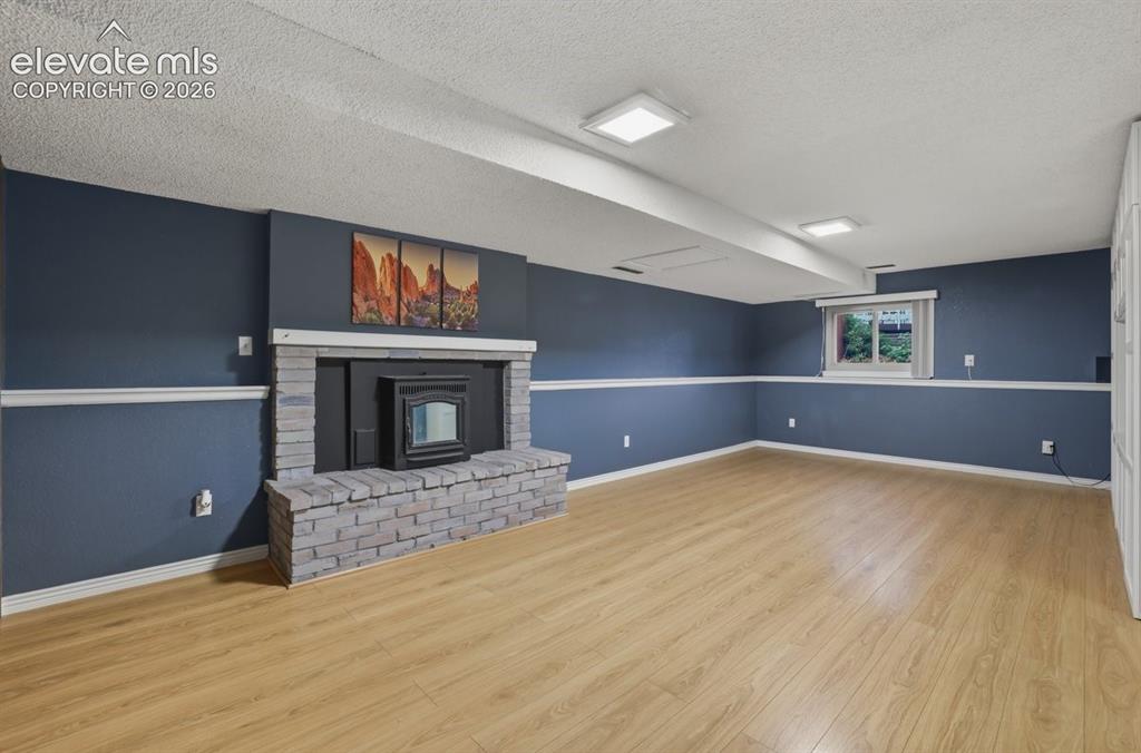 Image 33 of 45: large family room area with a pellet stove for the chilly CO evenings