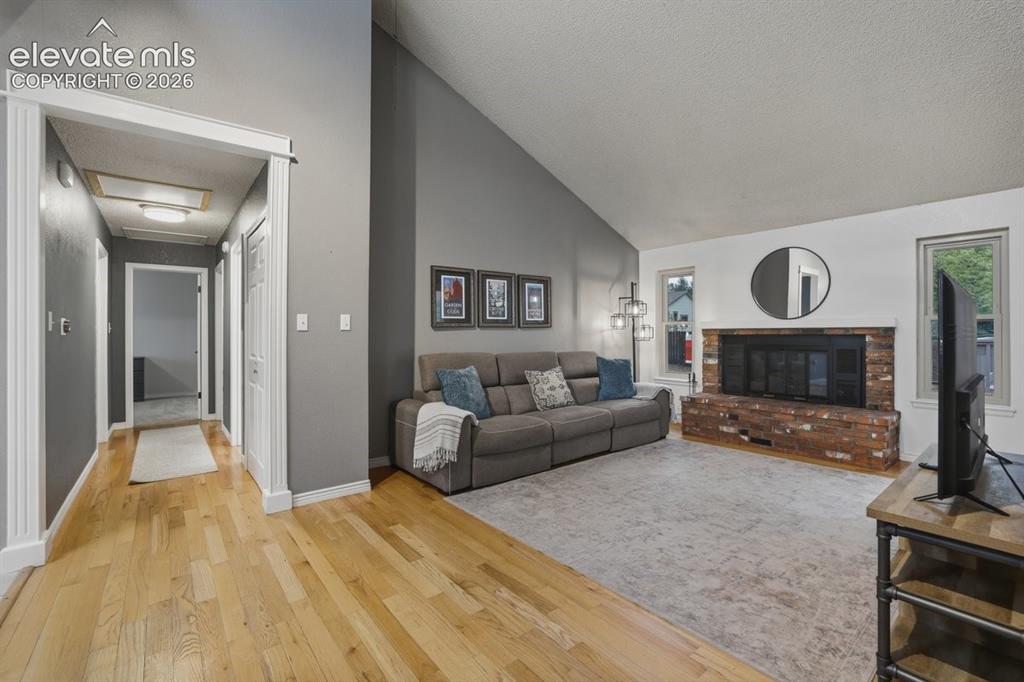 Image 8 of 45: cozy living room space with wood burning fireplace