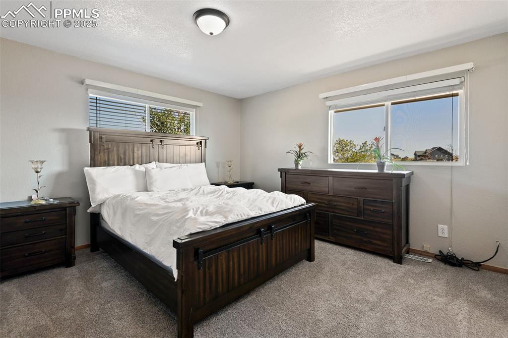 Image 18 of 40: Bedroom featuring carpet flooring and a textured ceiling