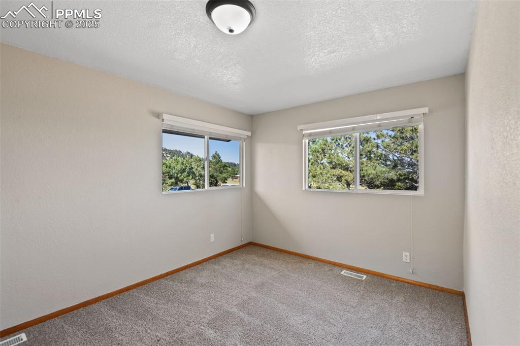 Image 23 of 40: Unfurnished room featuring plenty of natural light, a textured ceiling, and