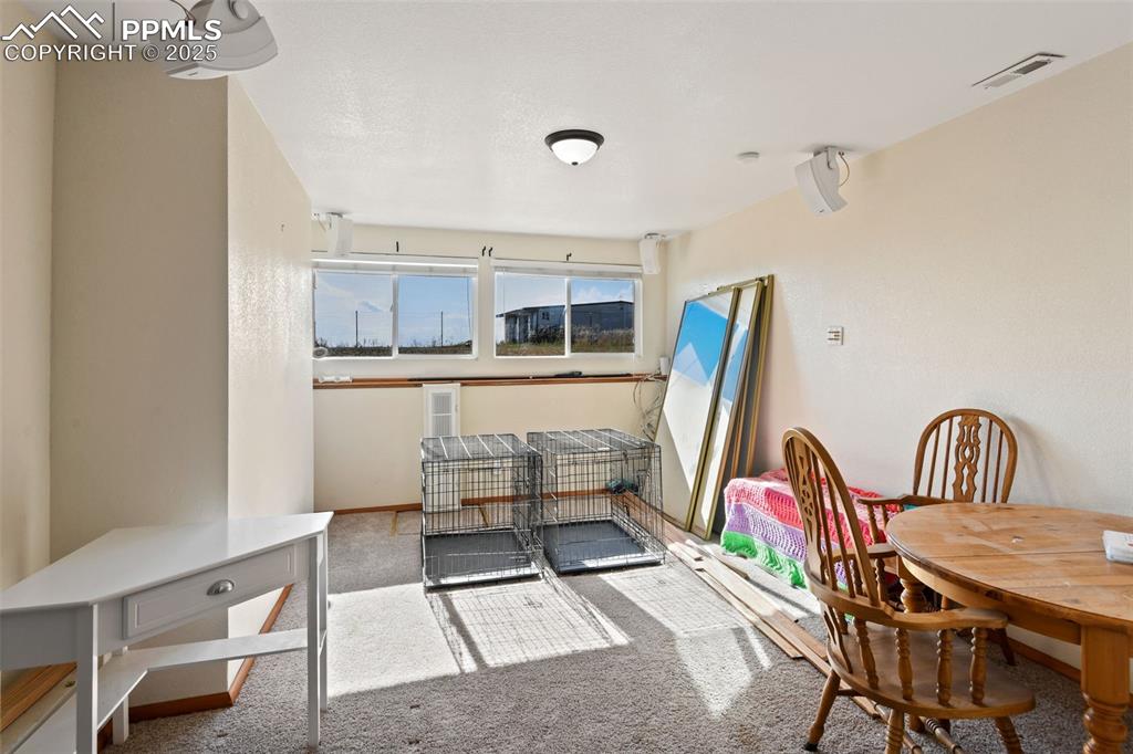Image 26 of 40: Carpeted dining room with baseboards