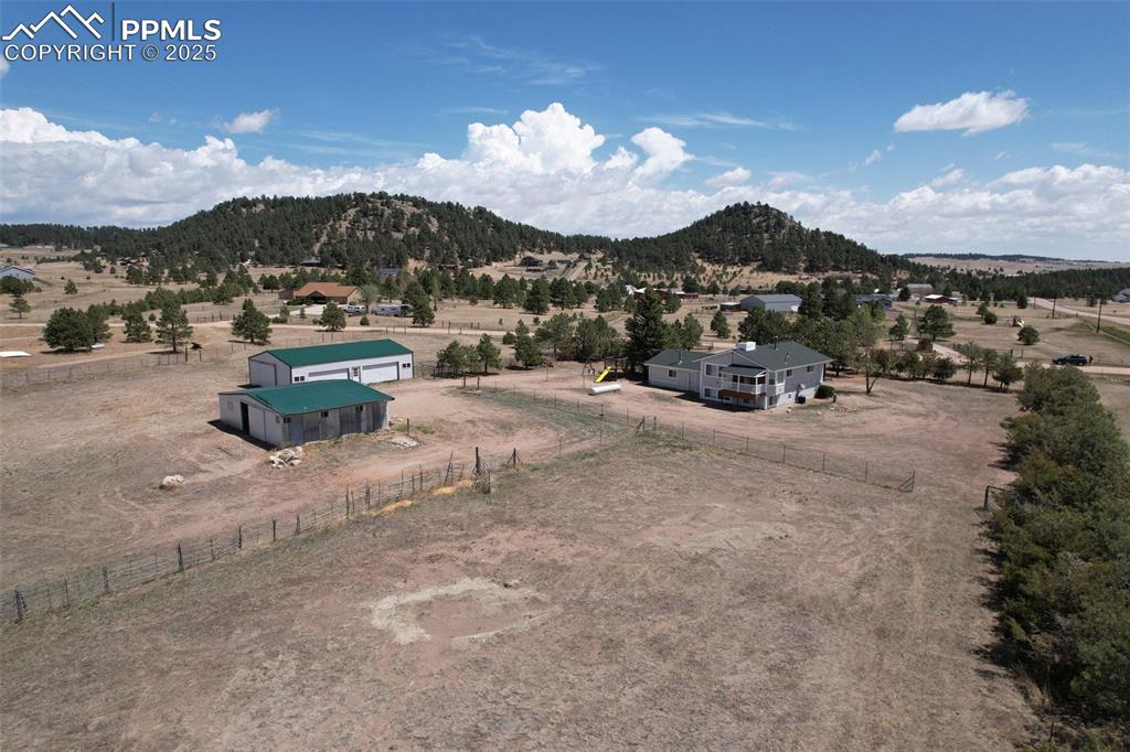 Image 39 of 40: Aerial view of sparsely populated area with a mountain backdrop