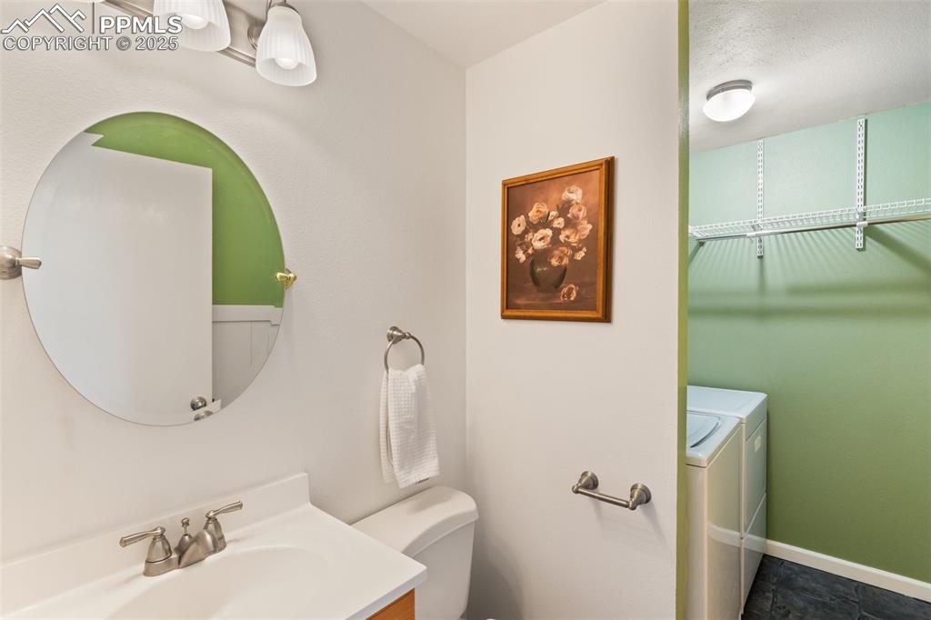 Image 16 of 44: Half bath/laundry combo off the garage gentrance.