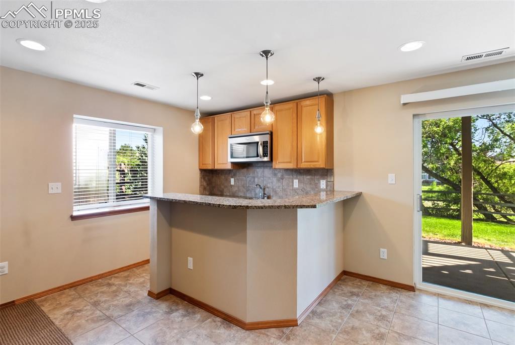 Image 26 of 44: Wet bar for entertaining or private guest space.