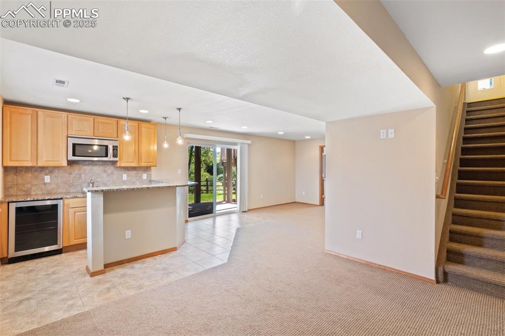 Image 27 of 44: Walk-out basement is fully finished.