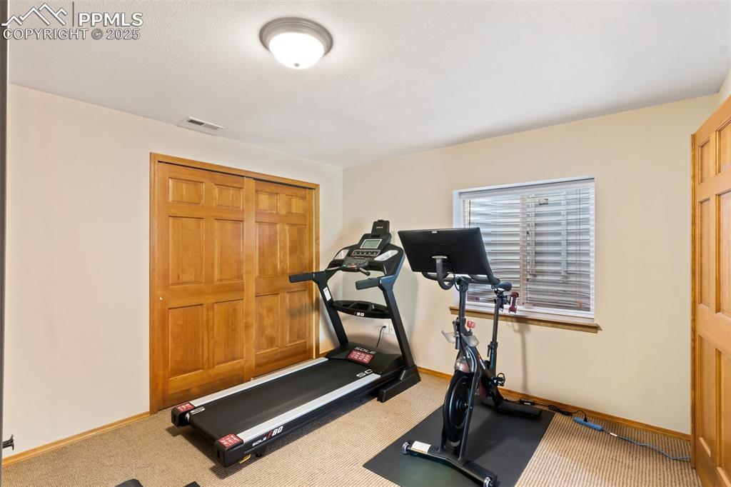 Image 34 of 44: Bedroom 4 is currently being used an an exercise room.