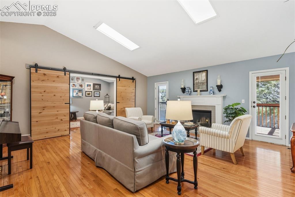 Image 3 of 35: Living room with walkout to deck, and office or 4th non-conforming bedroom 