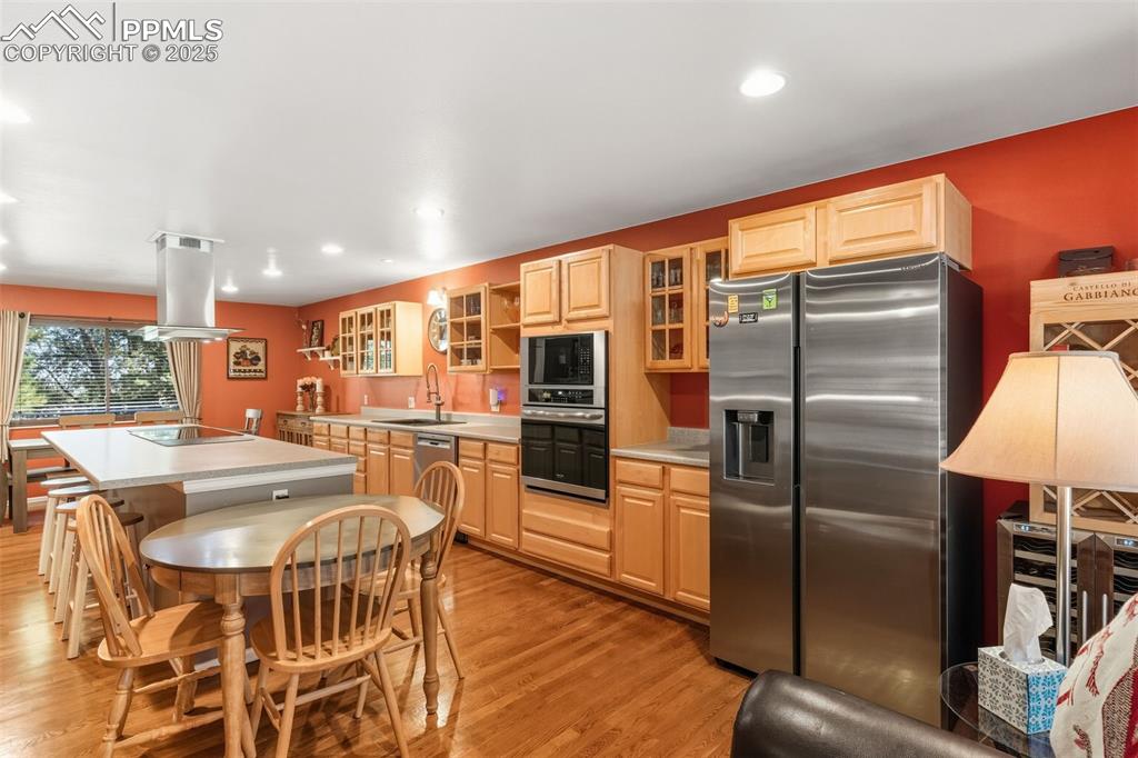 Image 9 of 35: Kitchen with all appliances, kitchen island, and lots of windows