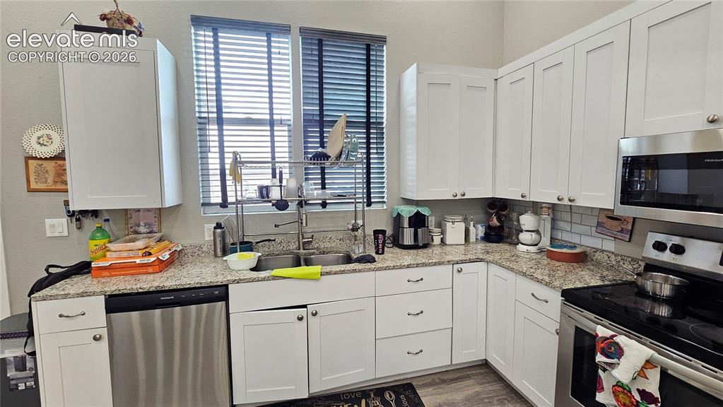 Image 15 of 48: Kitchen featuring white shaker-style cabinetry with brushed nickel hardware