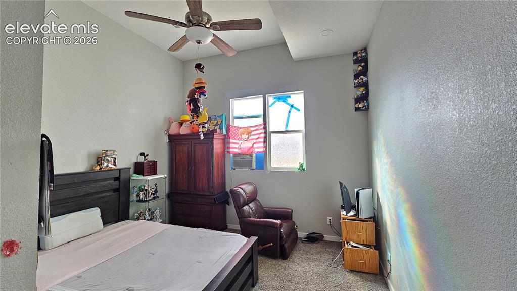 Image 20 of 48: Vaulted ceiling with an integrated ceiling fan, textured wall finish, and c
