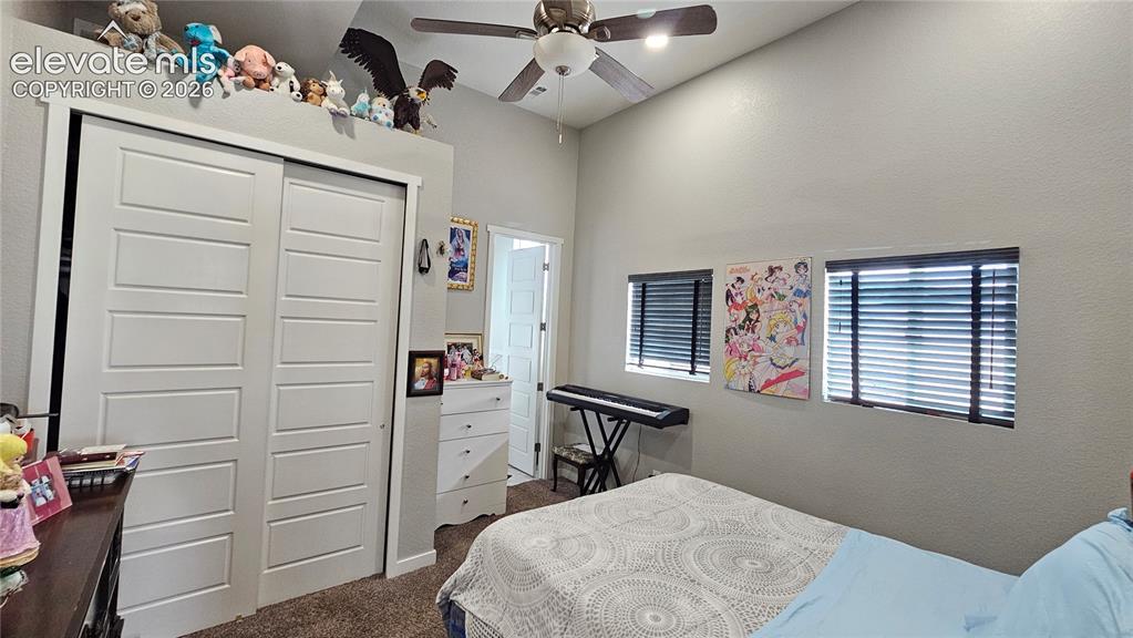 Image 22 of 48: Vaulted ceiling with a ceiling fan and recessed lighting, two windows with