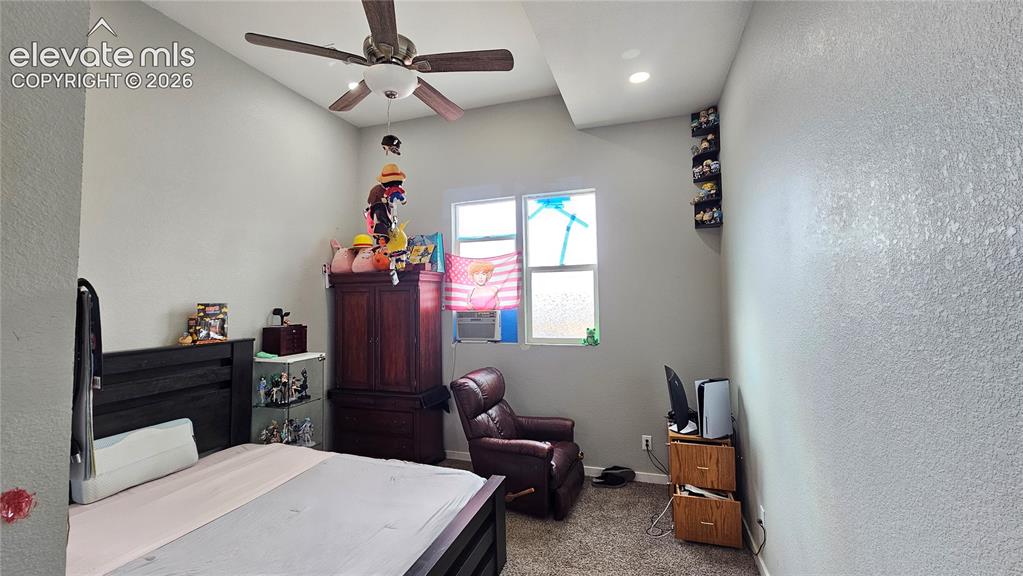 Image 27 of 48: Room featuring textured walls, a vaulted ceiling with a ceiling fan, and a