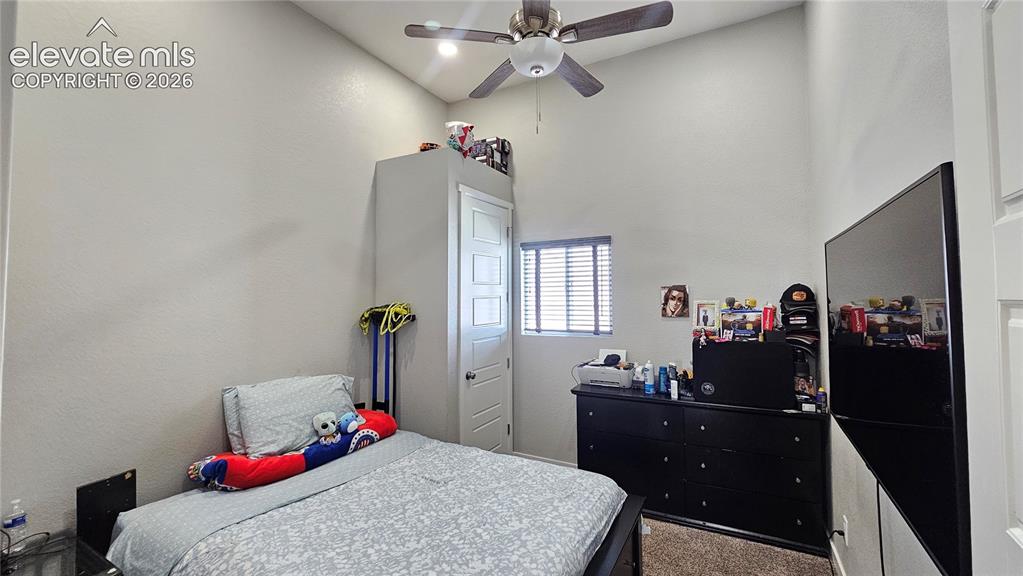 Image 28 of 48: Room featuring a high vaulted ceiling, neutral wall tones, and recessed win