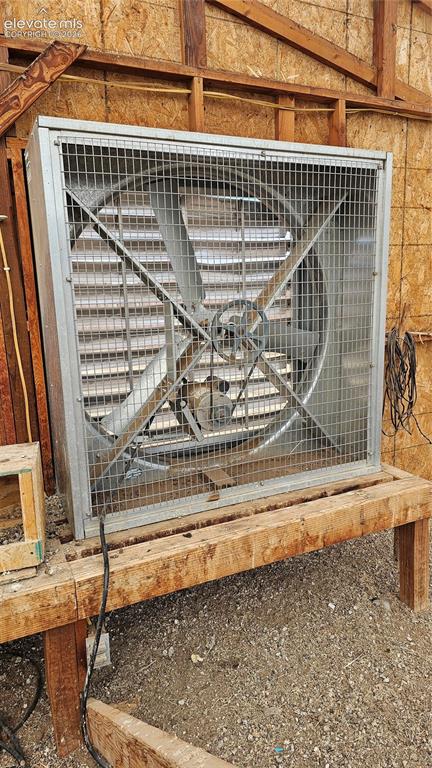 Image 3 of 48: Large industrial-style fan featuring a metal frame and protective grate