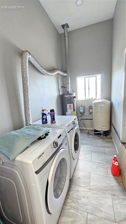 Image 35 of 48: Dedicated laundry area featuring modern tile flooring, recessed ceiling lig