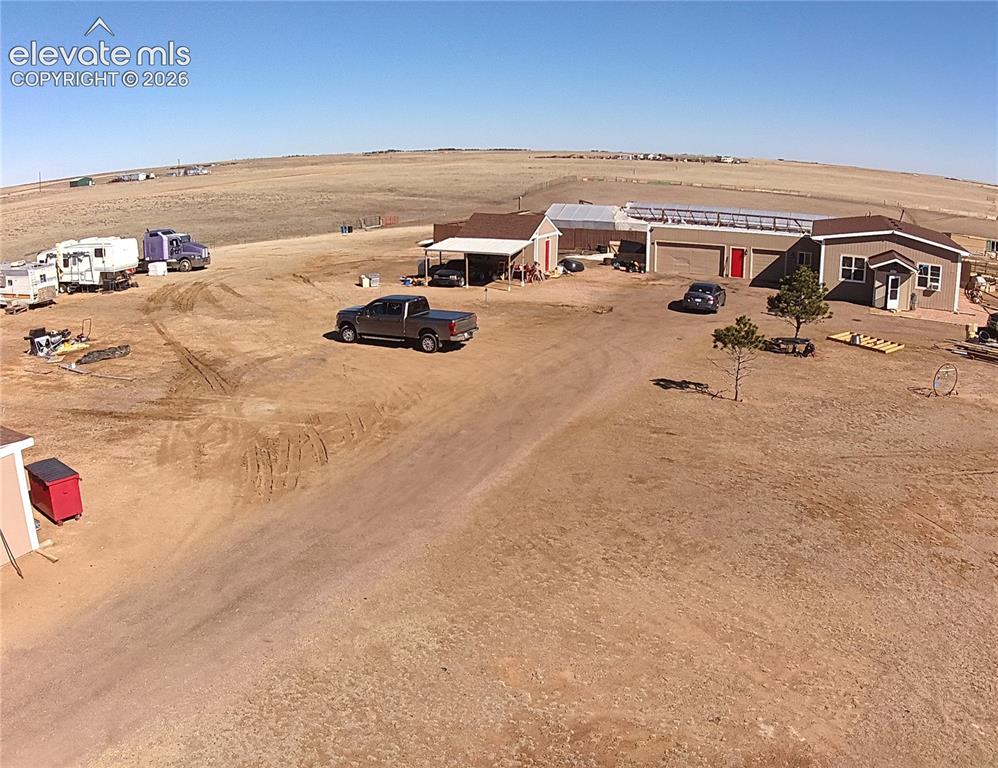 Image 42 of 48: Multiple structures including a main residence, two-door garage, and a sepa