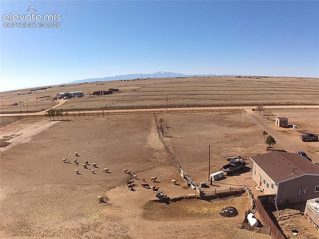 Image 46 of 48: Expansive rural property featuring a single-story residence with a brown sh