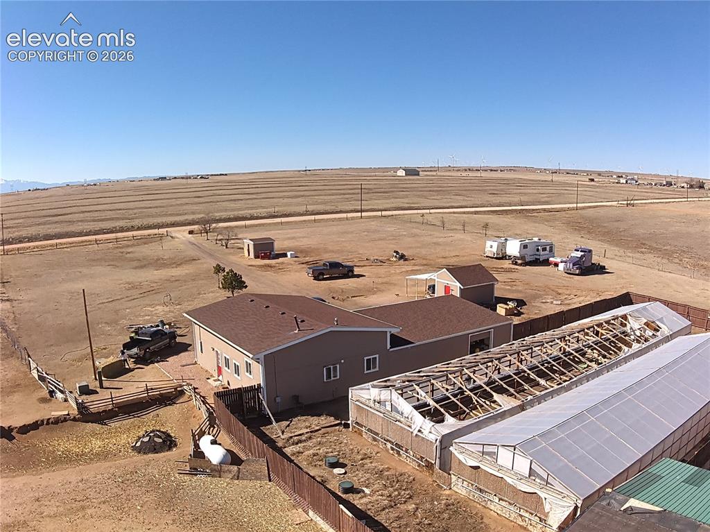 Image 47 of 48: Expansive rural property featuring a beige-sided residence with brown shing