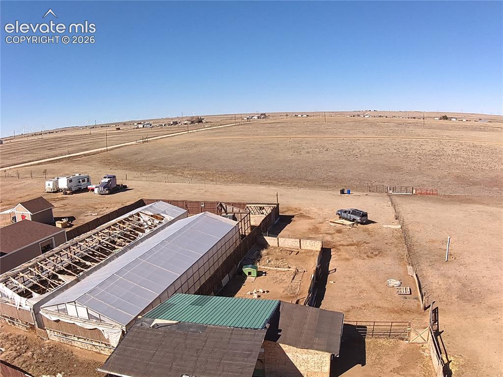 Image 48 of 48: Expansive property featuring multiple outbuildings, including two large str