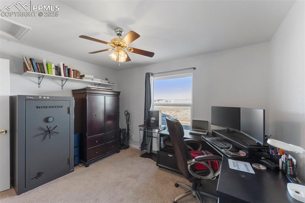 Image 18 of 38: Office space featuring light carpet and ceiling fan