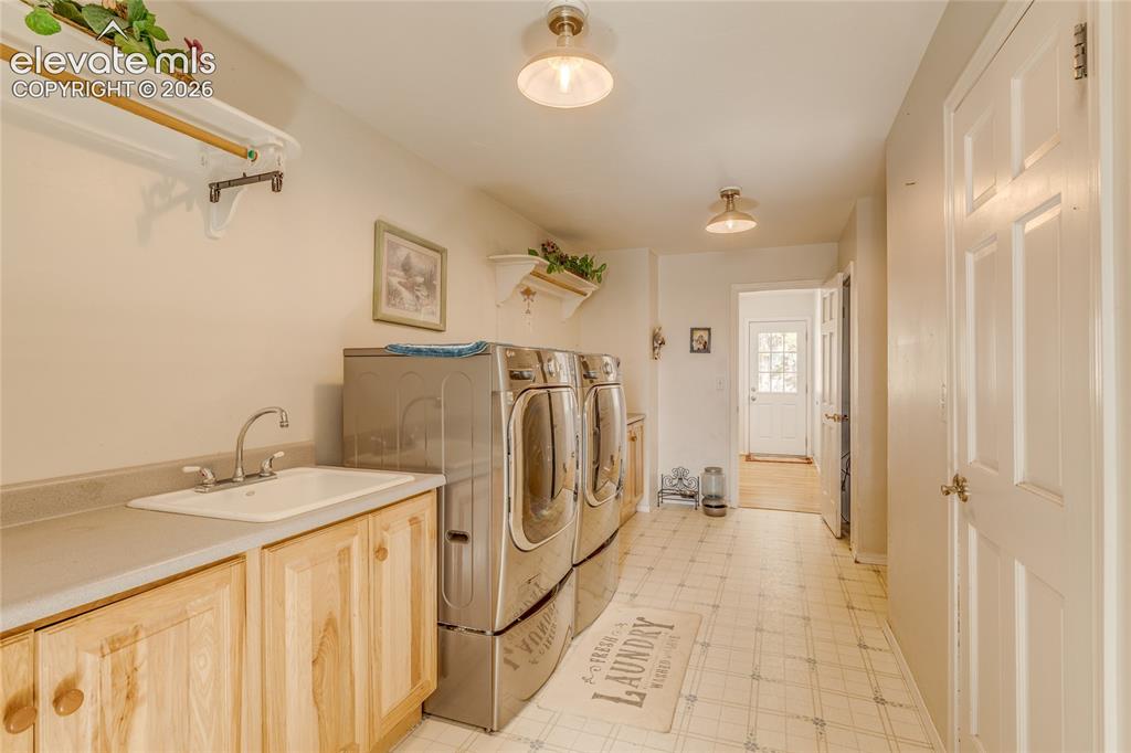 Image 19 of 32: Laundry room featuring washer and dryer and light floors