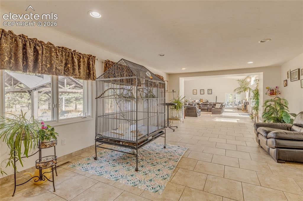 Image 20 of 32: Bedroom with recessed lighting and light tile patterned flooring