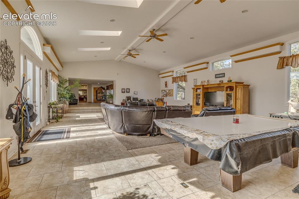 Image 21 of 32: Recreation room with a skylight, ceiling fan, and billiards table