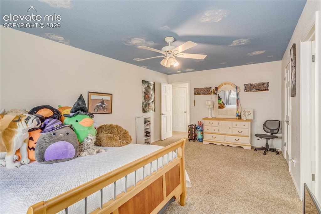 Image 24 of 32: Bedroom with carpet and ceiling fan