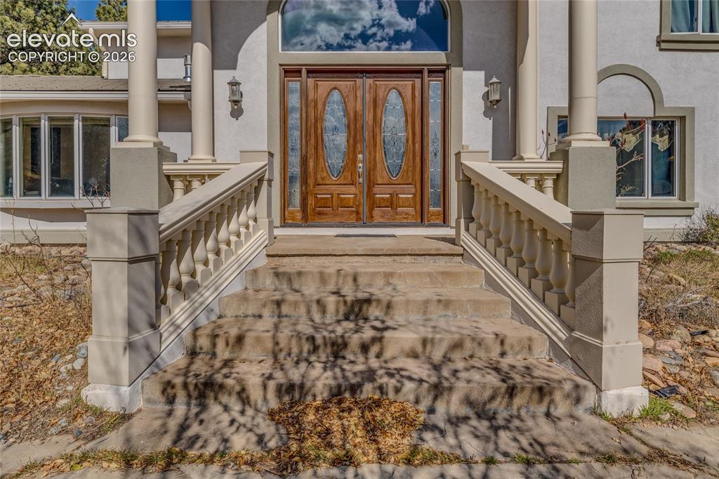 Image 3 of 32: Property entrance featuring stucco siding