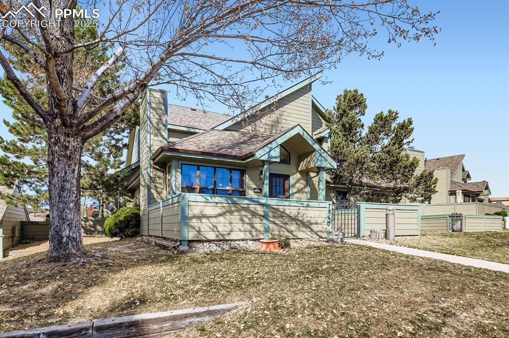 Image 2 of 25: View of front facade with roof with shingles and a gate