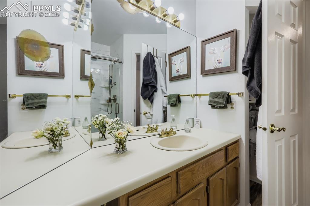 Image 20 of 25: Bathroom featuring vanity and a stall shower