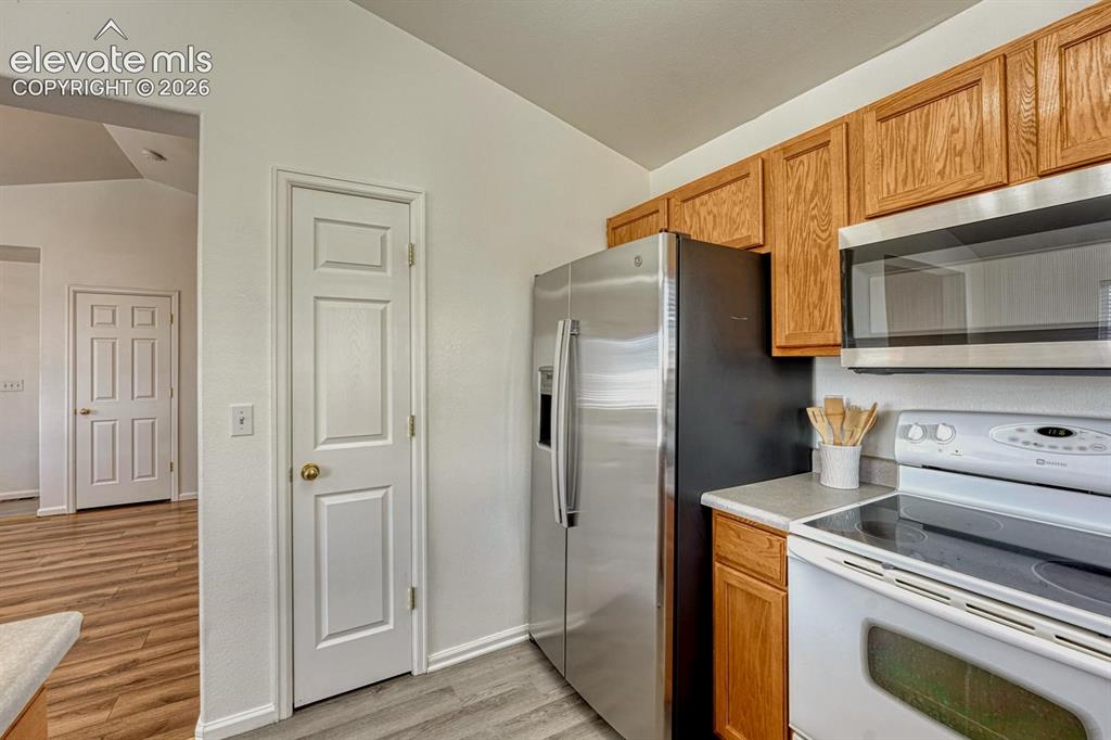 Image 17 of 35: Stainless steel refrigerator, smooth top range/oven, and built-in microwave