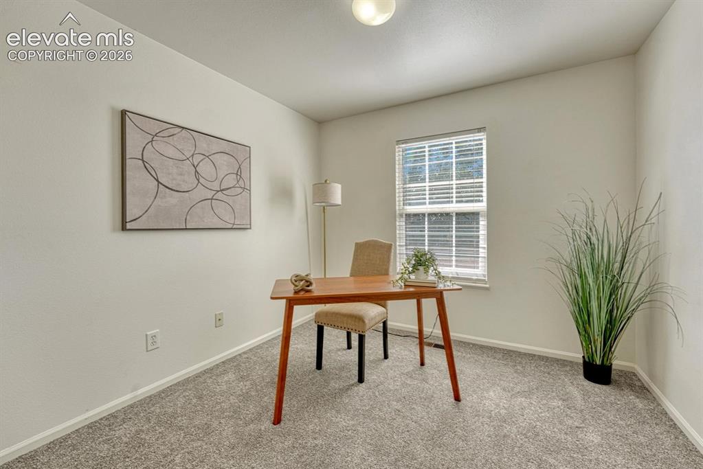 Image 19 of 35: Bedroom #1 (currently an office) with new carpet.