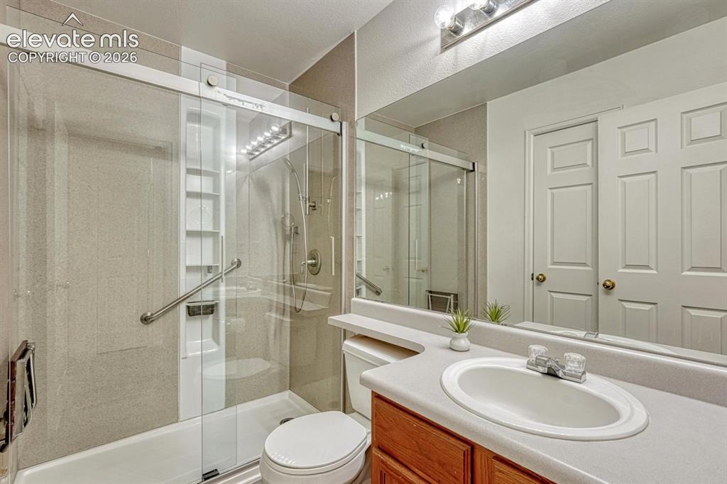 Image 22 of 35: Shower Bathroom with vanity, mirror, and tiled shower.