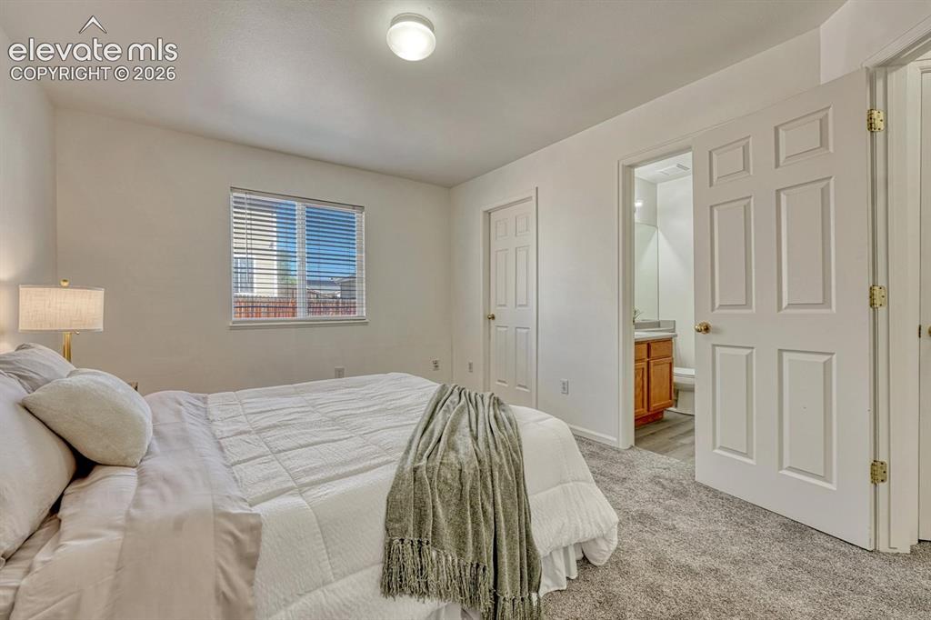 Image 25 of 35: Primary Bedroom with walk in closet and view into the adjoining Primary Bat