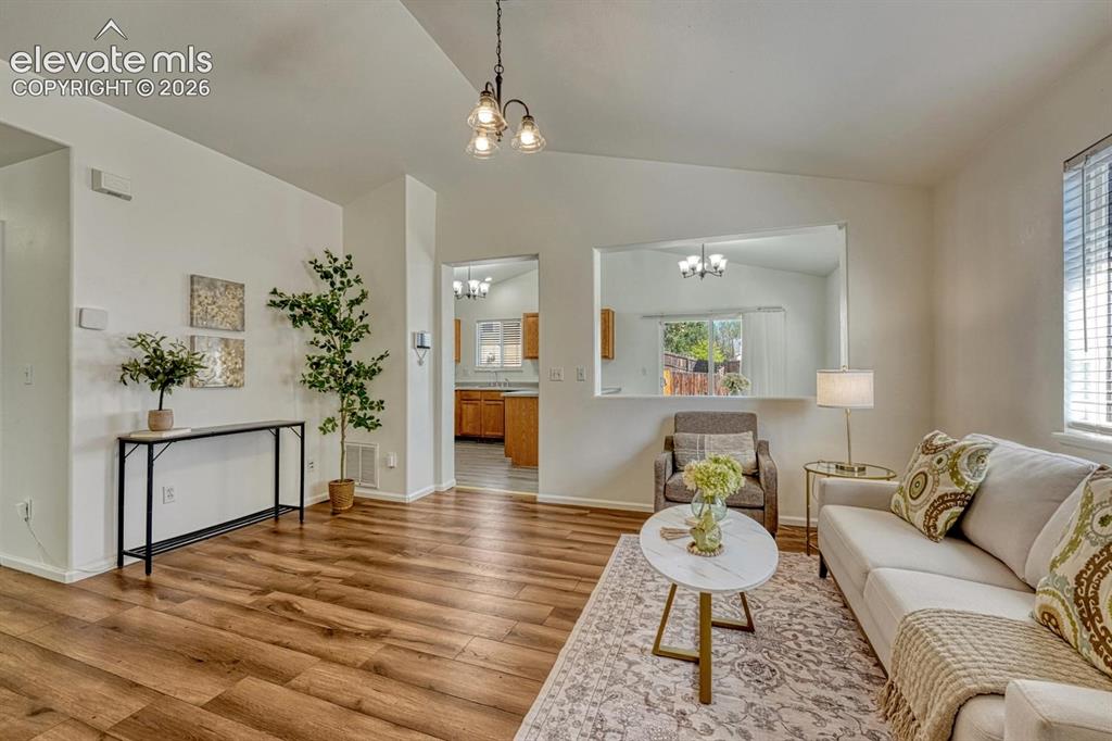 Image 3 of 35: Spacious vaulted living room, featuring durable luxury vinyl plank flooring