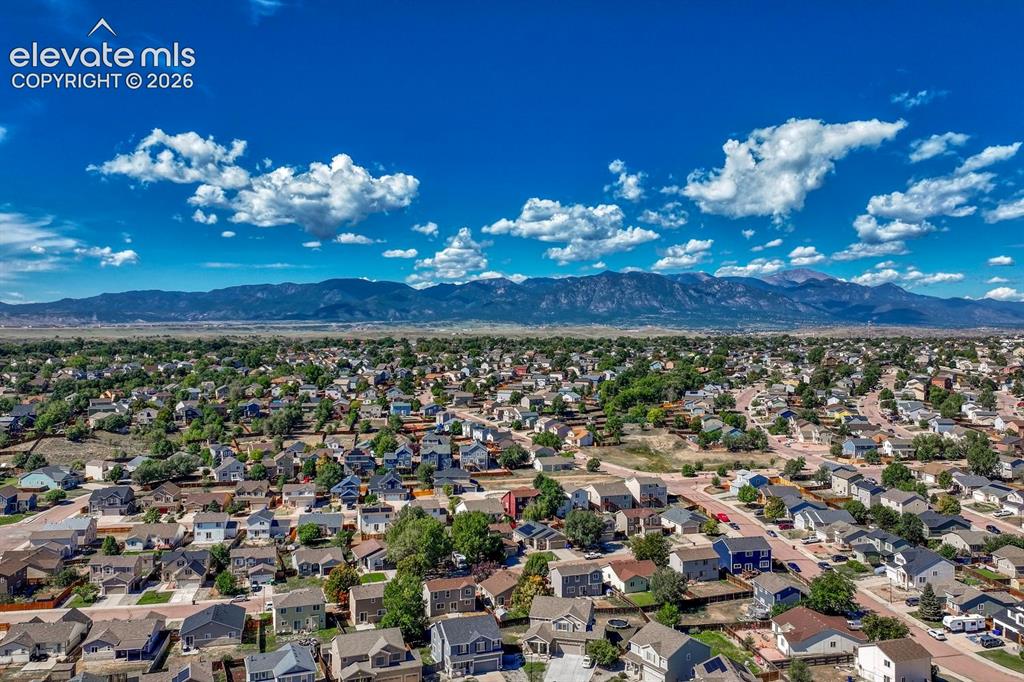 Image 34 of 35: Aerial view of community and surrounding mountains.