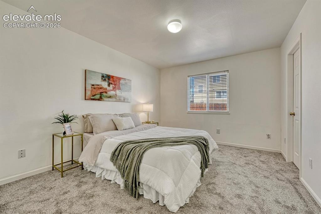 Image 7 of 35: Primary Bedroom with new carpet, a walk in closet, and adjoining bathroom.