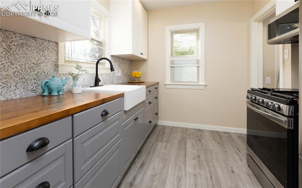 Image 5 of 29: Kitchen leads out side door and down to basement
