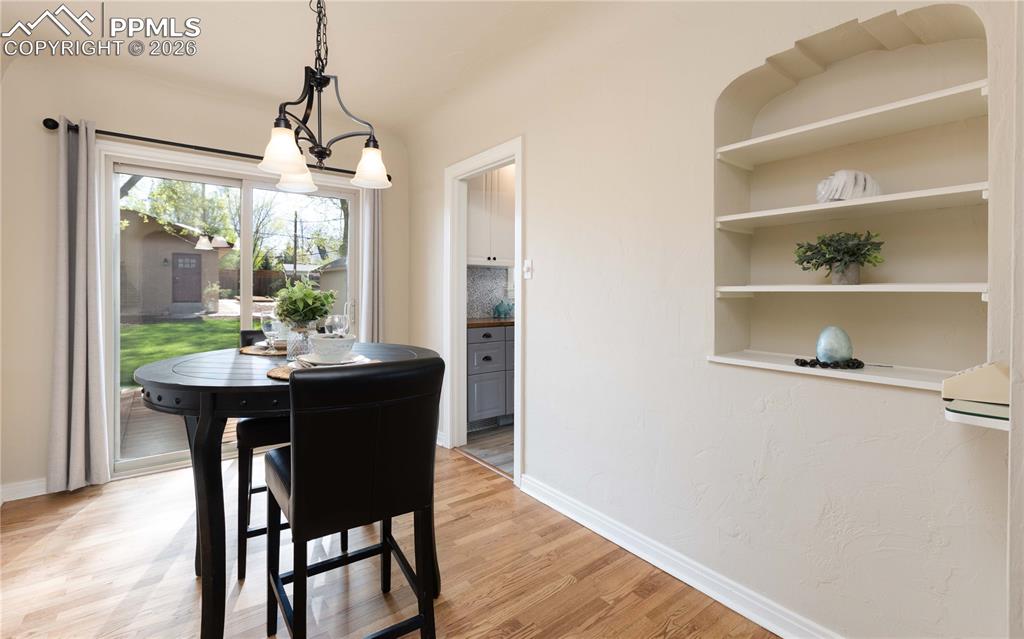 Image 8 of 29: Built-in shelves and a workspace area