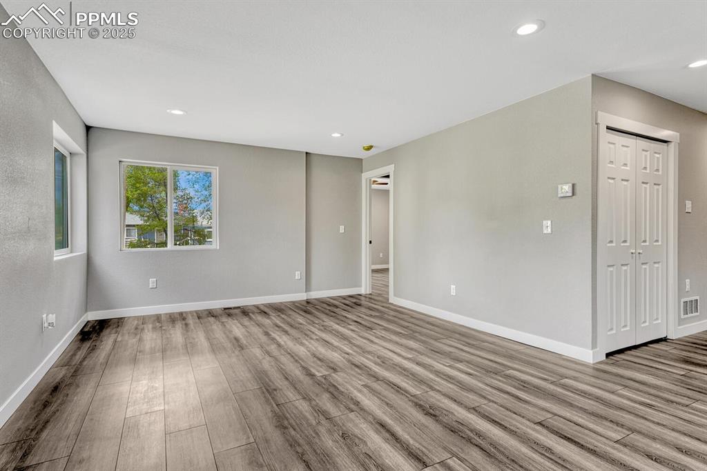 Image 12 of 50: Unfurnished living room featuring recessed lighting and light wood finished
