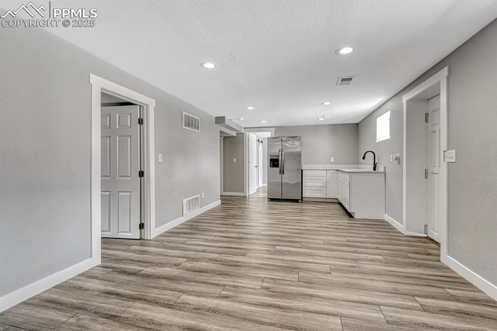 Image 33 of 50: Unfurnished living room featuring recessed lighting, light wood-style floor
