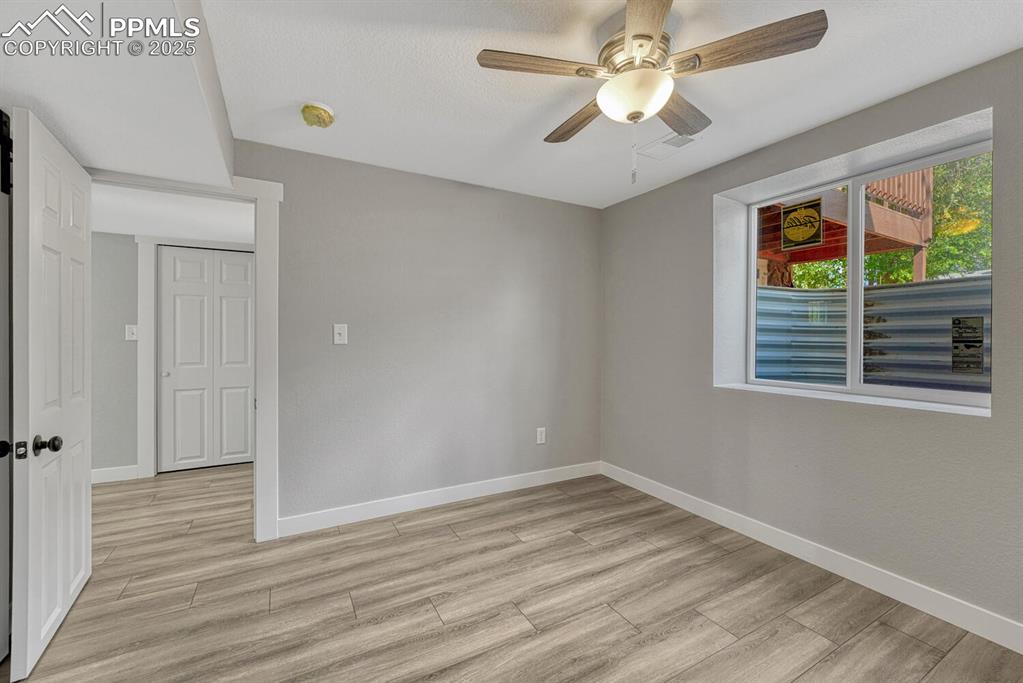 Image 41 of 50: Spare room with light wood-style flooring and ceiling fan