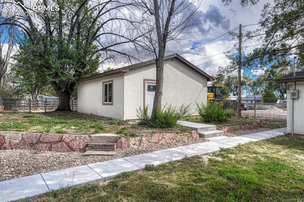 Image 49 of 50: View of property exterior with stucco siding