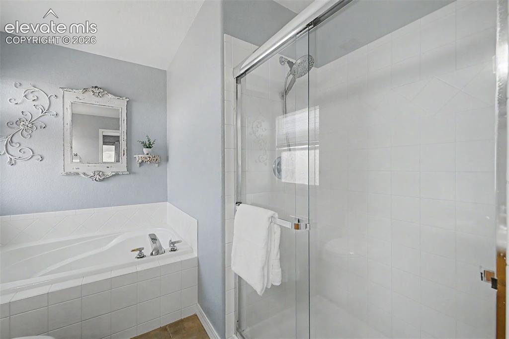 Image 18 of 43: Primary Ensuite Bathroom has Free-Standing Shower